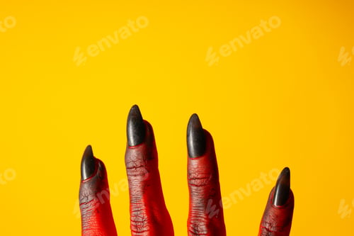 Preview: Creepy, red hands of a monster on a yellow background