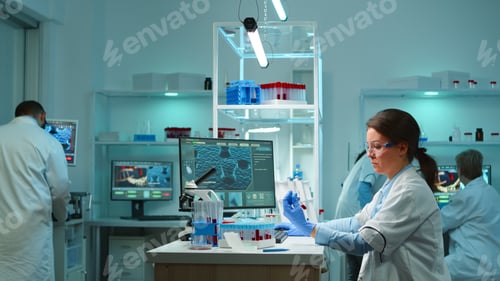 Preview: Medical lab worker analyzing blood serum conducting virus test