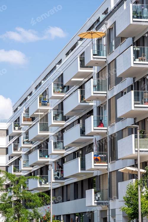 Preview: Modern apartment building with a yellow parasol