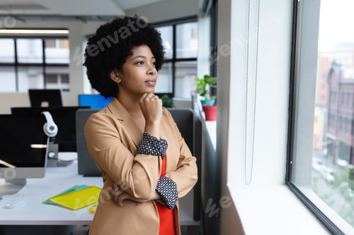 Preview: Mixed race businesswoman working in creative office