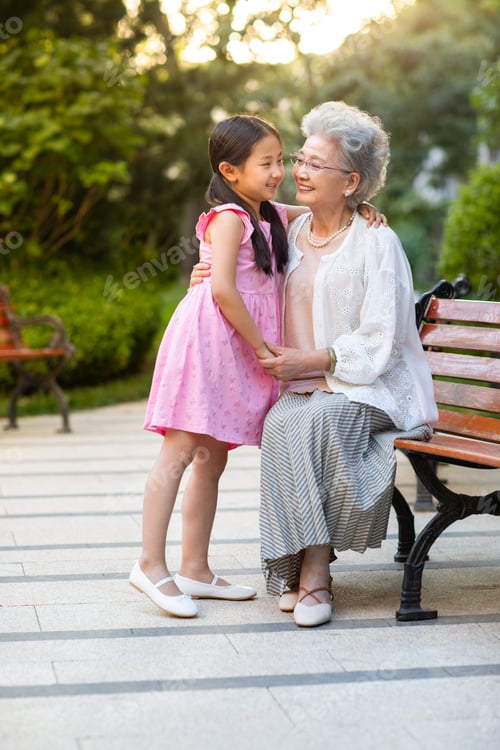 Preview: Happy Chinese grandmother and granddaughter relaxing in park
