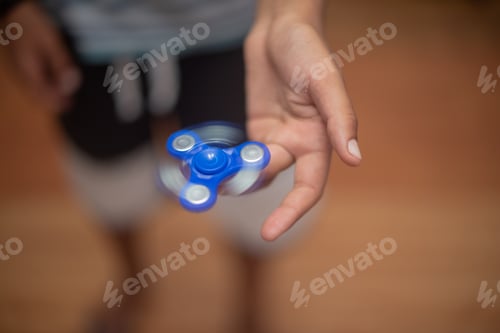 Preview: Close up of boy holding fidget spinner on his finger