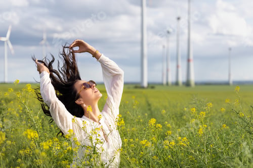 Preview: Young adult beautiful female model woman enjoy walking in agricultural farm rapeseed field in sunny