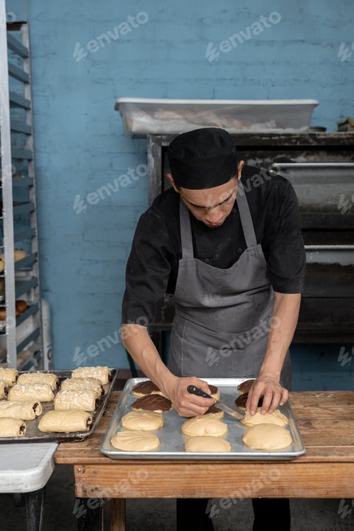 Preview: A young Hispanic baker is doing marks to make Mexican chocolate shells