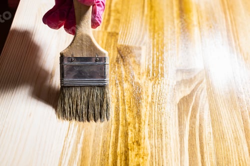 Preview: wooden board is covered with wood stain close up