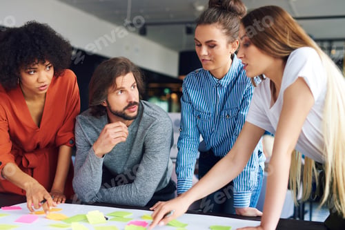 Preview: Young coworkers sharing concepts together