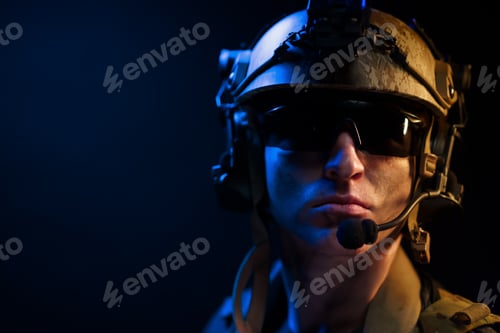 Preview: Portrait of special forces soldier in helmet and glasses in the dark