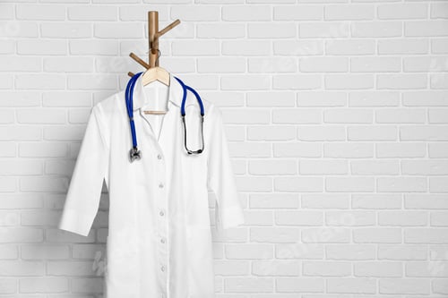 Preview: Doctor's White Coat and Stethoscope Hanging on Rack