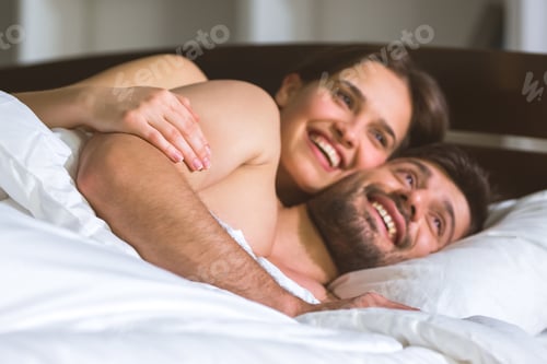 Preview: The happy man and woman lay on the bed
