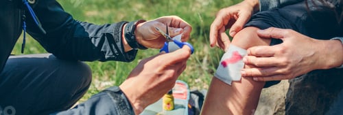 Preview: Man healing knee to woman who has been injured trekking