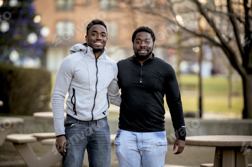 Preview: Cute selective focus shot of two friends smiling and posing together