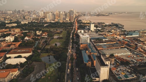 Preview: Sunset cityscape with designed park and ponds at ocean bay aerial. Port town of Manila at summer
