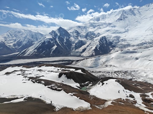 Preview: Snow-covered peaks rise magnificently against a bright blue sky
