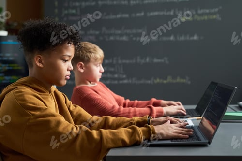 Preview: Teenage Boys of Different Ethnicities Using Laptops in Classroom Setting