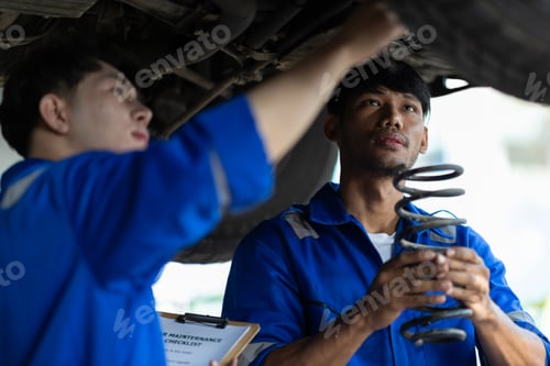 Preview: Auto mechanic checking springs and shocks.