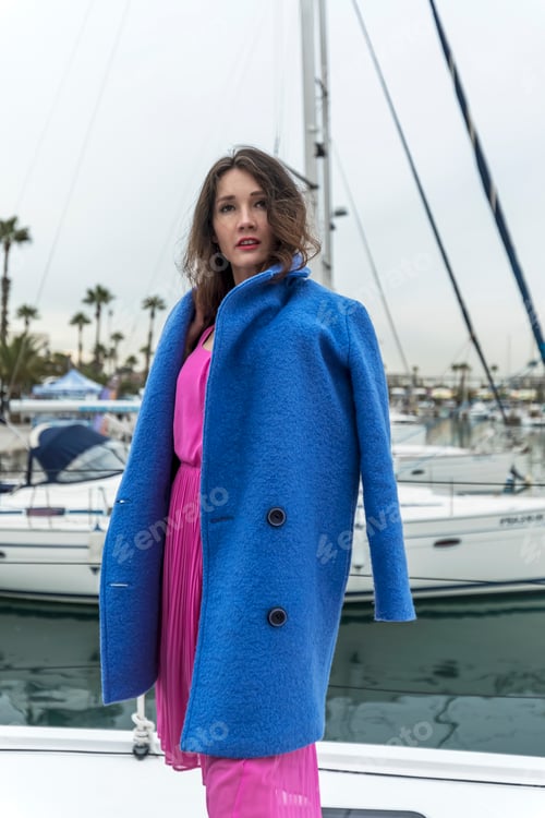 Preview: Young model woman is posing on a boat at the yacht marina