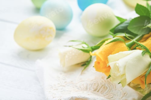 Preview: Happy Easter. Easter eggs on rustic table with white and yellow roses. Natural dyed colorful eggs in