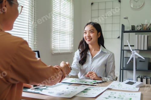 Preview: Businesswomen shaking hands on environmental, social, and governance deal