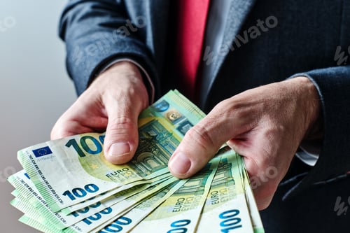 Preview: Businessman offering payment in new hundred euro banknotes