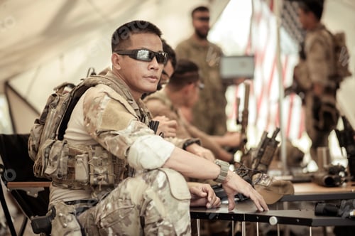 Preview: Soldiers in camouflage uniforms planning on operation in the camp