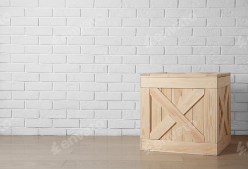 Preview: Wooden crate on floor near brick wall, space for text