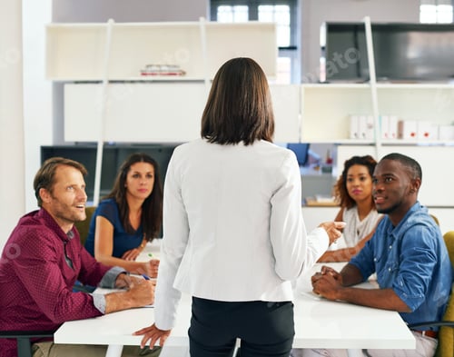 Preview: OK team, lets get down to business. Shot of a group of office workers in a meeting.