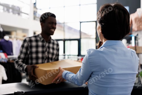 Preview: Man standing at store counter desk