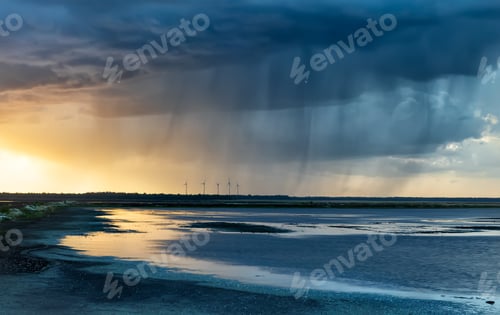 Preview: dramatic rain storm over lake at sunset