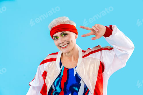 Preview: Happy and funny senior old woman on colorful background