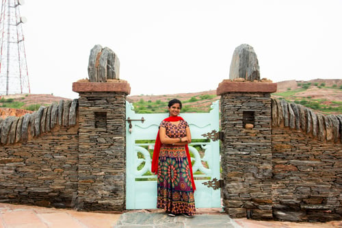 Preview: Woman in front of old stone wall