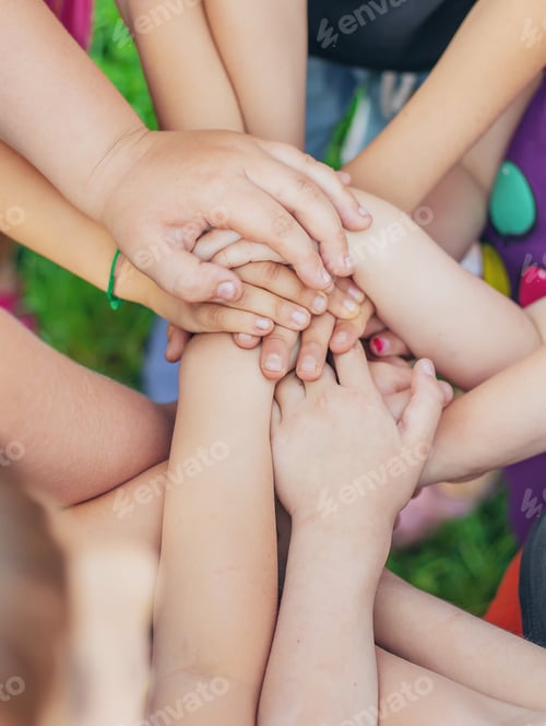 Preview: Children's hands together, street games. Selective focus.