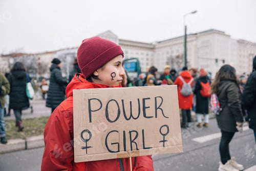 Preview: Teenage girl with a Power Girl banner, international women's day