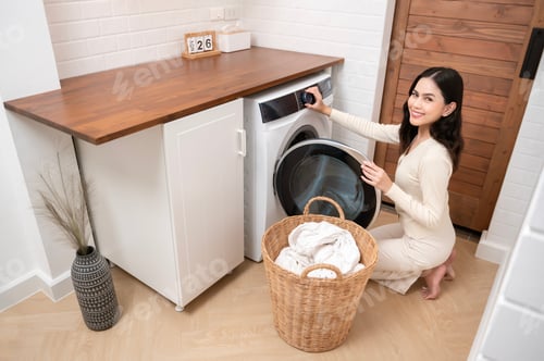 Preview: Young woman is doing laundry in home