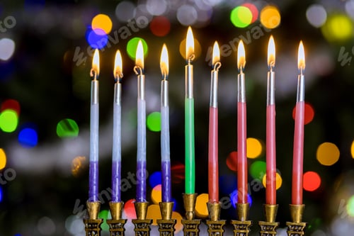 Preview: Symbol of Hanukkah and the Jewish holiday in Hanukkiah Menorah lit by candles in blurred bokeh with