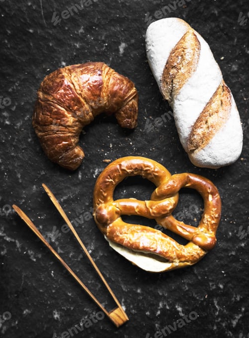 Preview: Croissant pretzel and baguette with wooden tongs