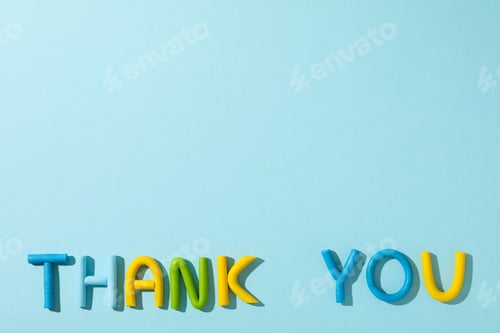 Preview: The word "thank you" from colored plasticine on a blue background.
