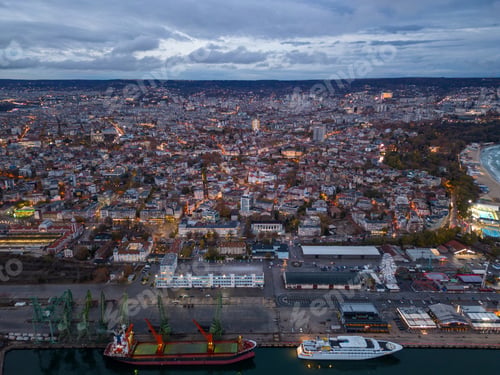 Preview: Aerial view of Varna city port at sunset. Night urban landscape.