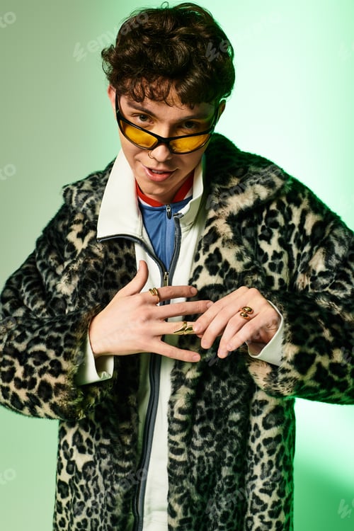 Preview: Stylish man exudes confidence in trendy fashion against vibrant backdrop