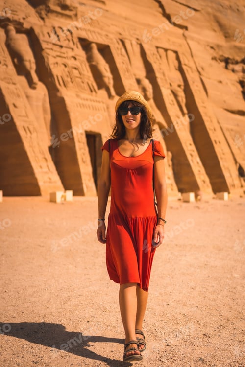 Preview: A Young Girl In Red Dress Visiting The Egyptian Temple Of Nefertari Near Abu Simbel In Southern