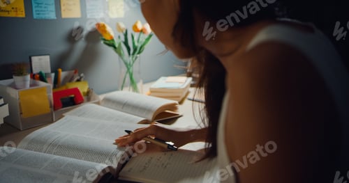 Preview: Young Asia teen girl student distance learning lesson and doing homework sitting at desk.