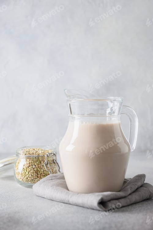 Preview: Vegan green buckwheat milk in glass jug, plant based milk replacer.