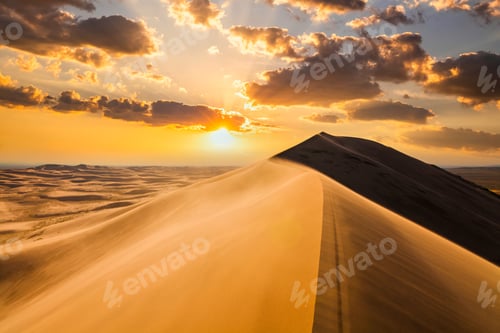Preview: Sunset over the sand dunes in the desert. Arid landscape of the Sahara desert.