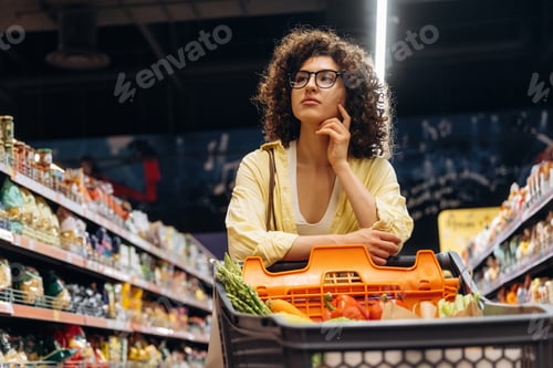 Preview: In glasses, looking forward. Gorgeous woman is in the grocery store