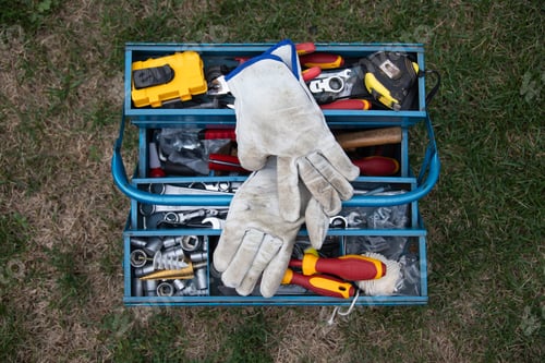 Preview: An open tool box photographed from above with many different tools in it.