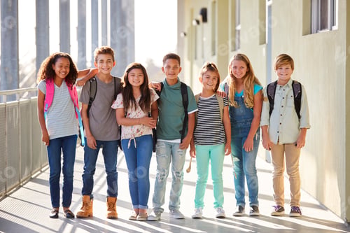 Preview: Elementary school kids stand in corridor looking at camera
