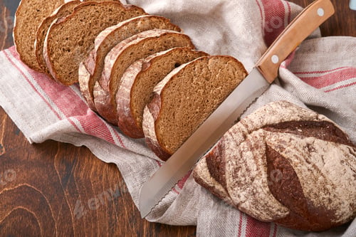 Preview: Fresh homemade rye bread. Traditional spelled sourdough bread cut into slices on a rustic wooden bac