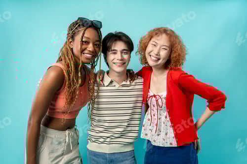 Preview: Portrait of diverse Generation Z friends posing on isolated blue screen.