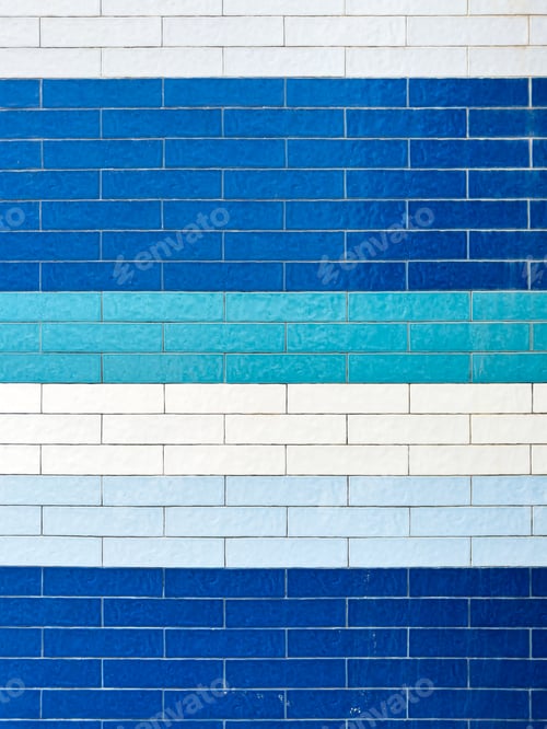 Preview: A textured wall featuring rectangular tiles in a mosaic of various blue and white shades