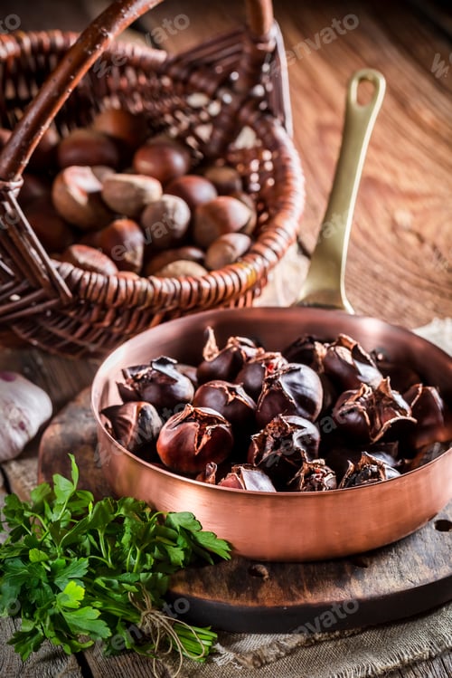 Preview: Delicious chestnuts with parsley on old wooden table