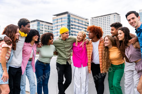 Preview: Happy playful multiethnic group of young friends bonding outdoors